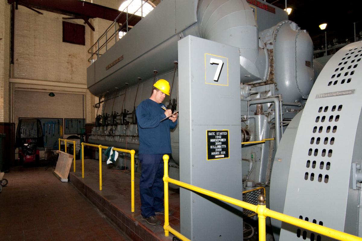 Power Plant Employee with Engine Generator